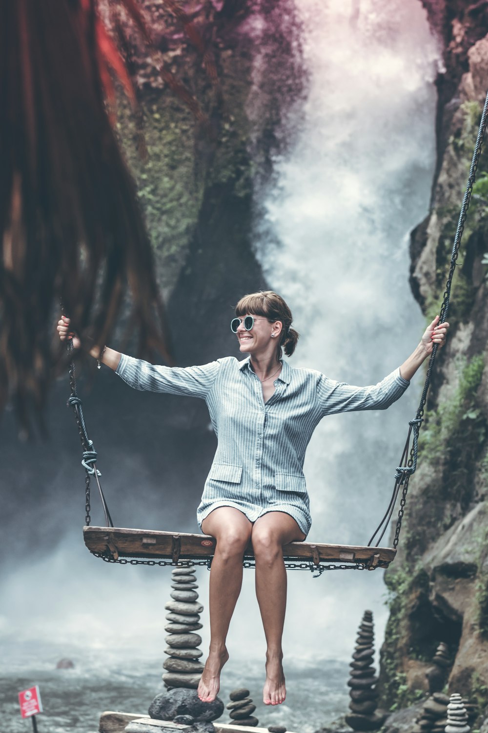 woman sitting on brown wooden swing