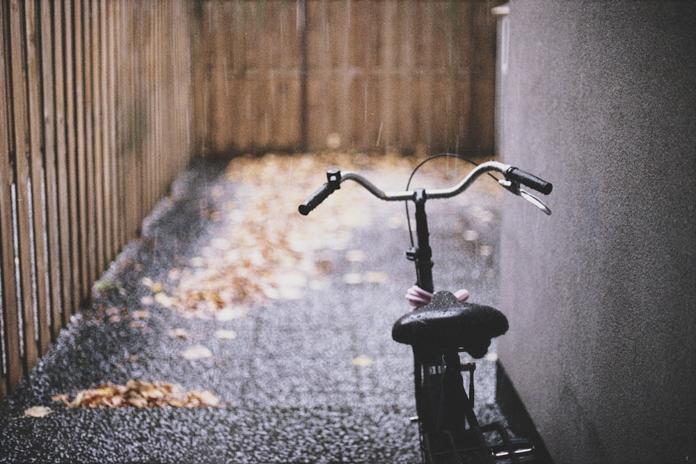 black bike parked near wall