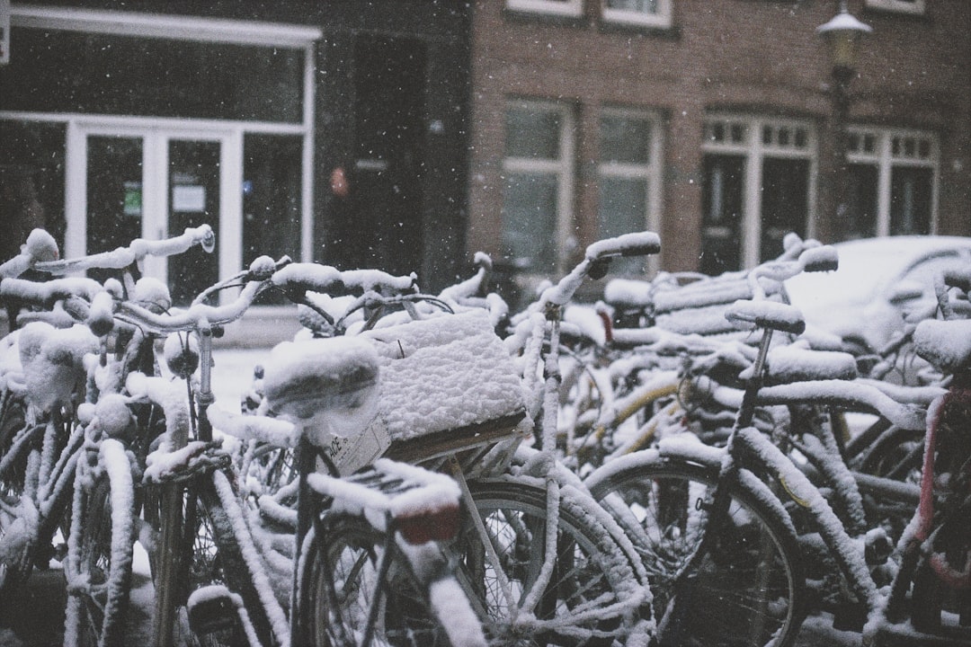 bike parked on street covered with snow, This is an analogue photo (35mm)