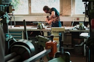 selective focus photography of man using angle grinder