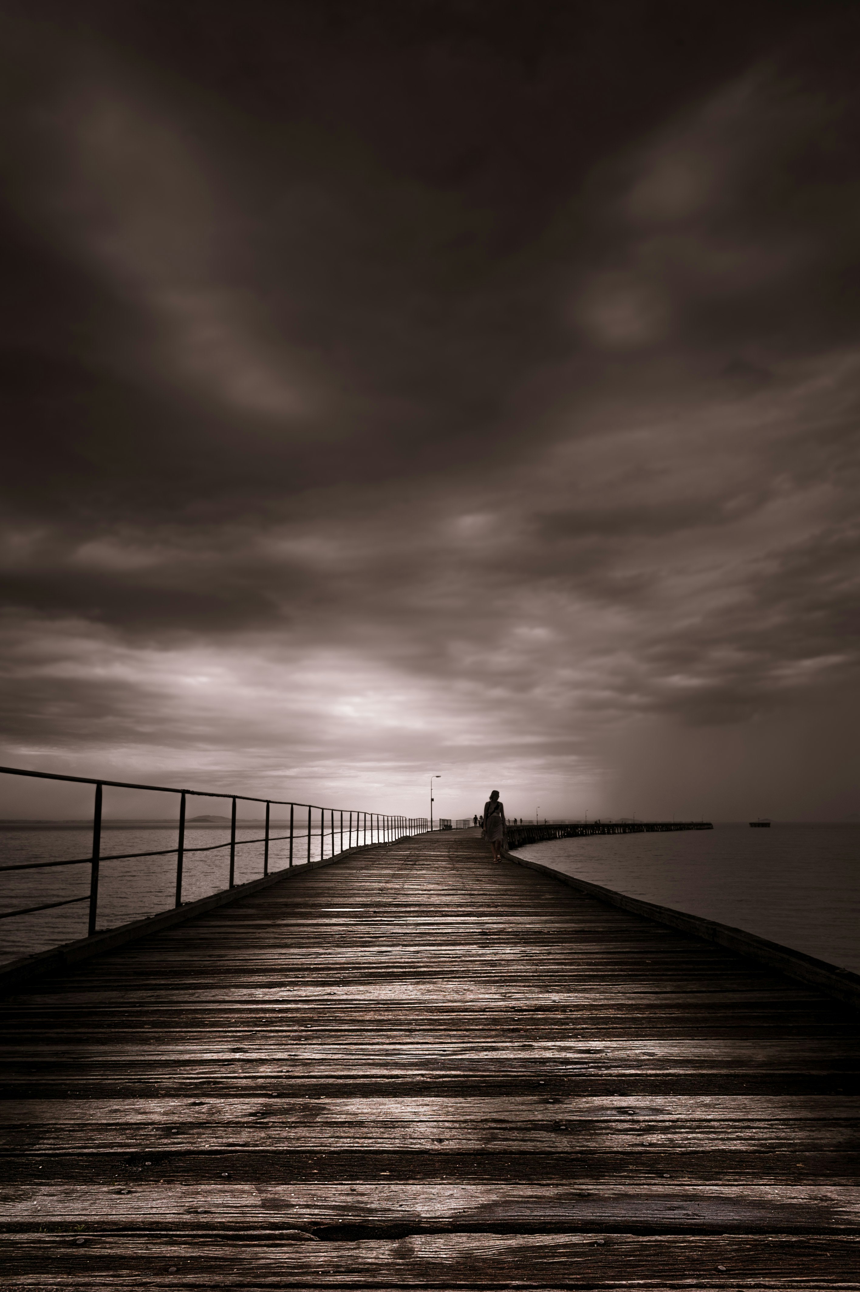 person standing on wooden dock