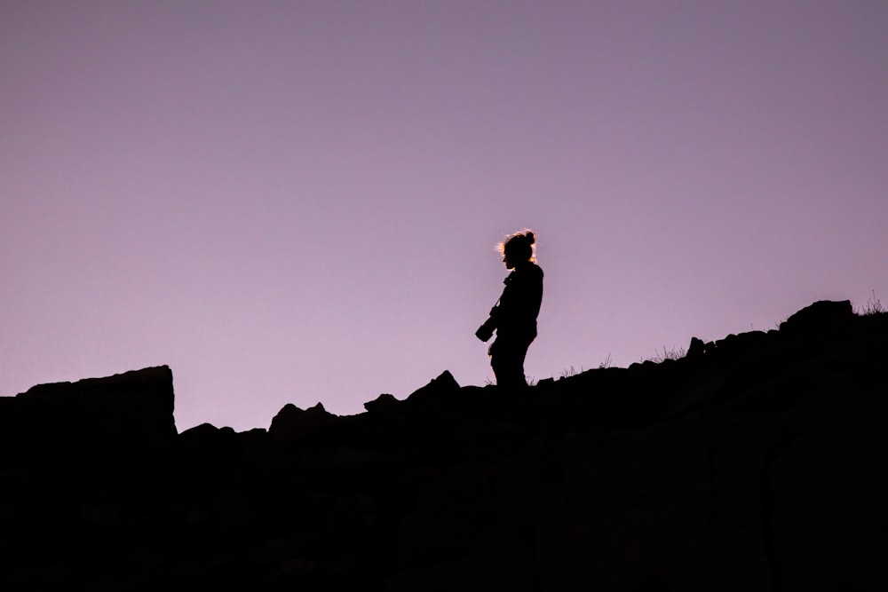silhouette of person holding DSLR camera