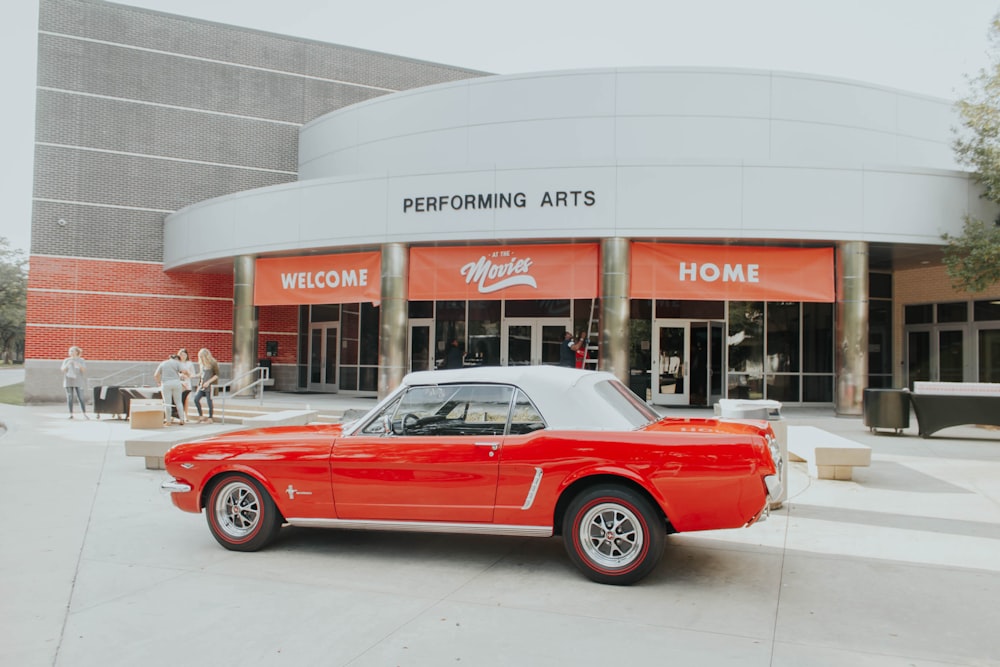 parked red and white coupe