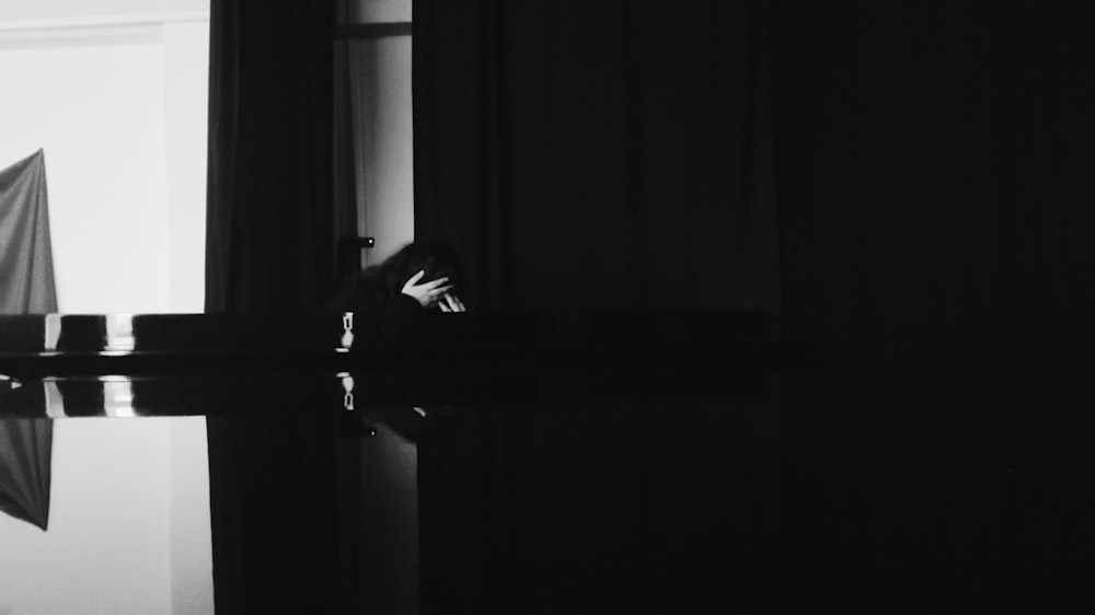 a black and white photo of a person holding an umbrella