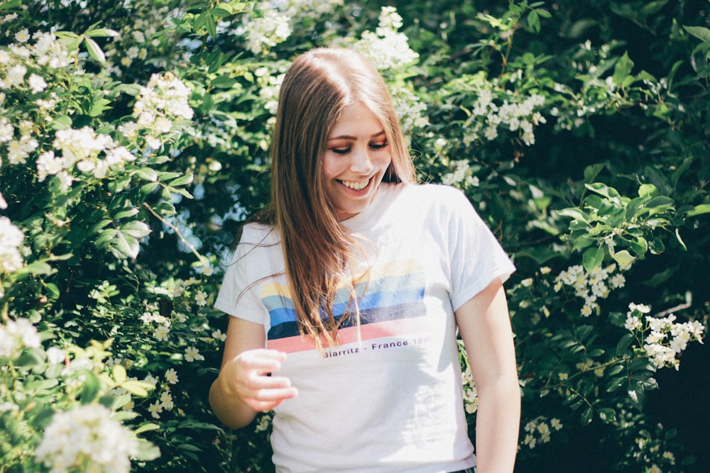 woman standing in front of a hedge