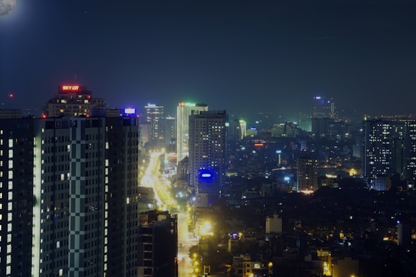 Nighttime cityscape with illuminated buildings and a clear sky over Atlanta.