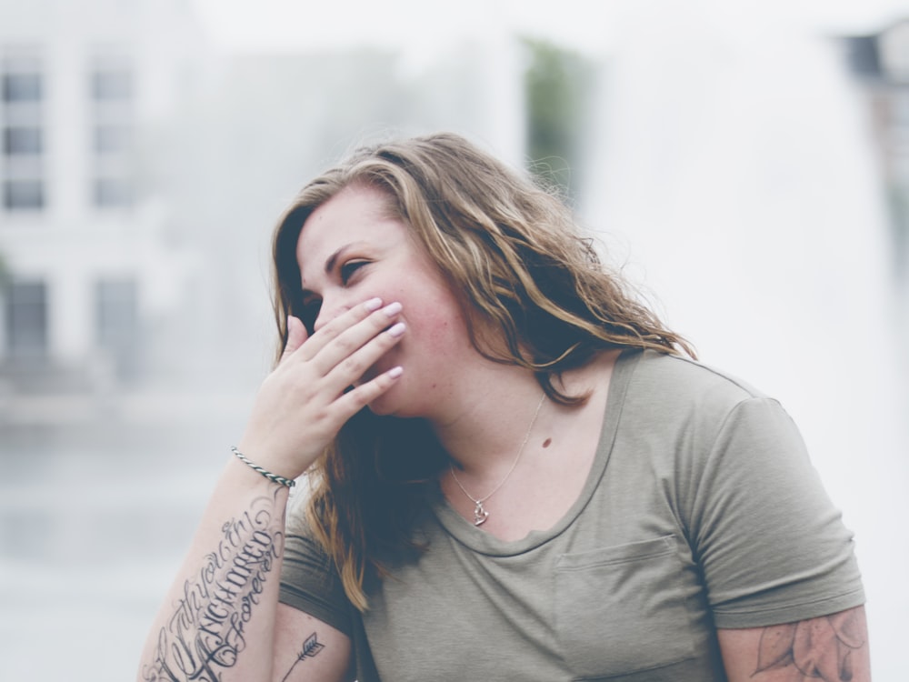 woman covering her mouth