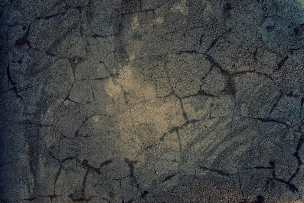 a close up of a rock wall with cracks