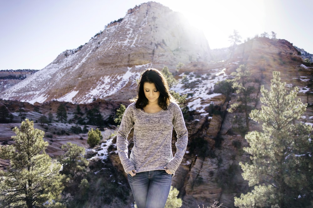 woman standing near tree and alp mountain