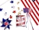 An arrangement featuring American-themed items, including a pinwheel with red, white, and blue blades, a string of star-shaped lights, a plastic card with 'USA' on it, a bag of Cracker Jack popcorn, and a section of the American flag. The festive items are spread against a white background.