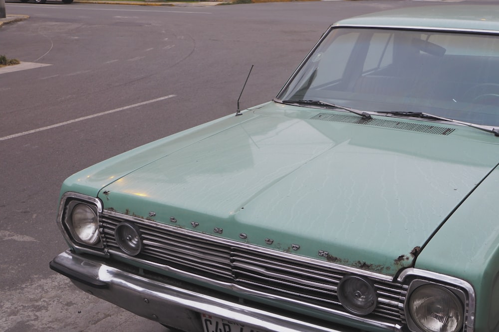 vintage teal car park on street during daytime