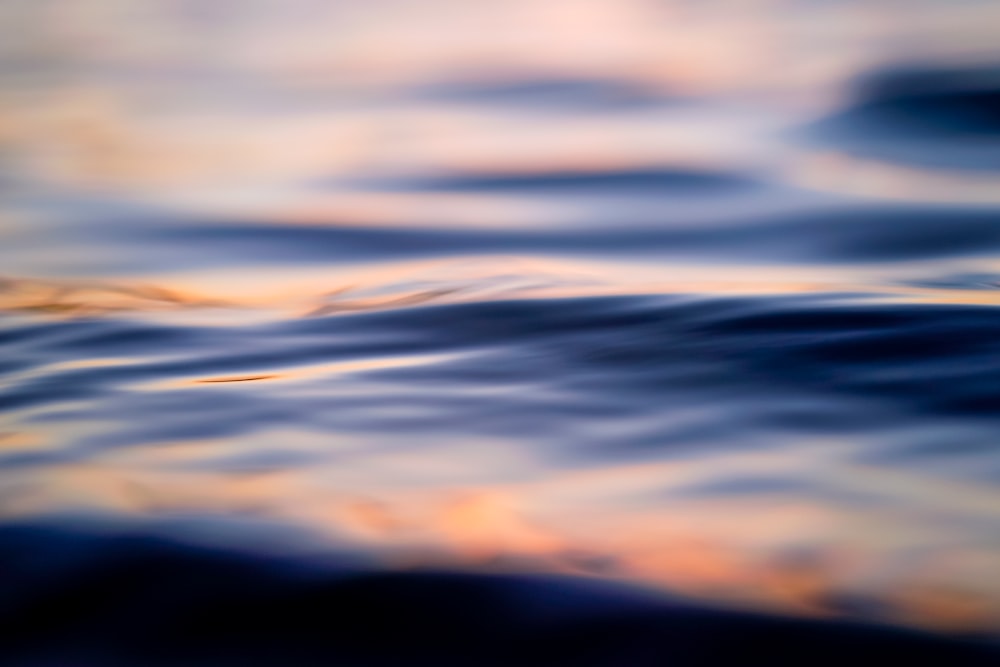 a blurry photo of the ocean with waves