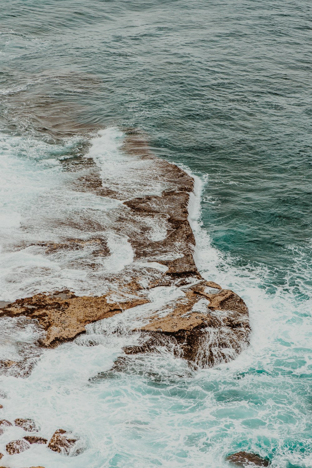 rock formation beside body of water