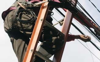 man on top of electrical wires