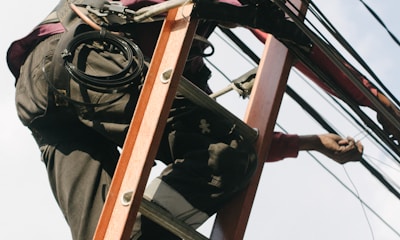 man on top of electrical wires