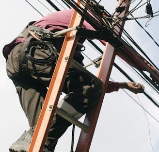 man on top of electrical wires