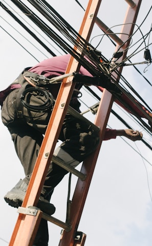 man on top of electrical wires