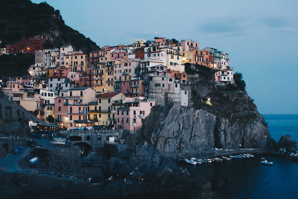 building on rock near body of water at blue hour