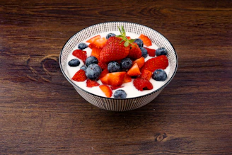 strawberry and blackberries on top of brown table
