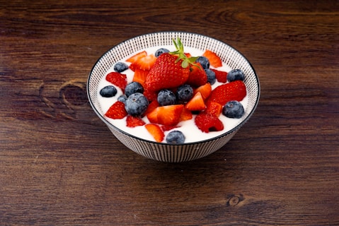 strawberry and blackberries on top of brown table