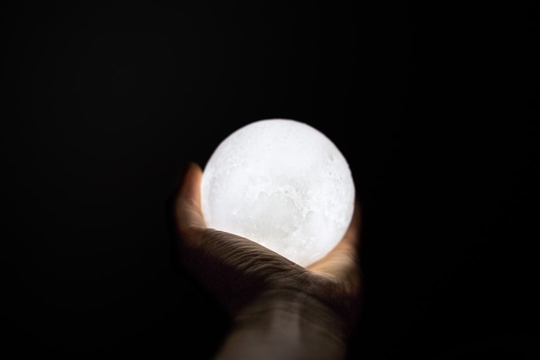 person holding ball lamp