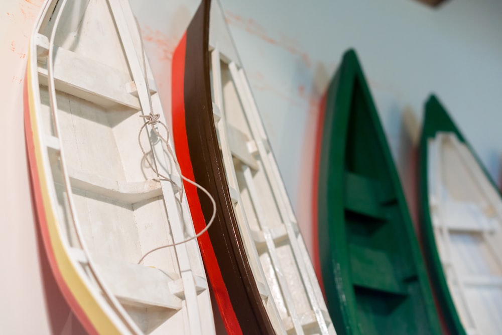 four wooden canoe miniatures