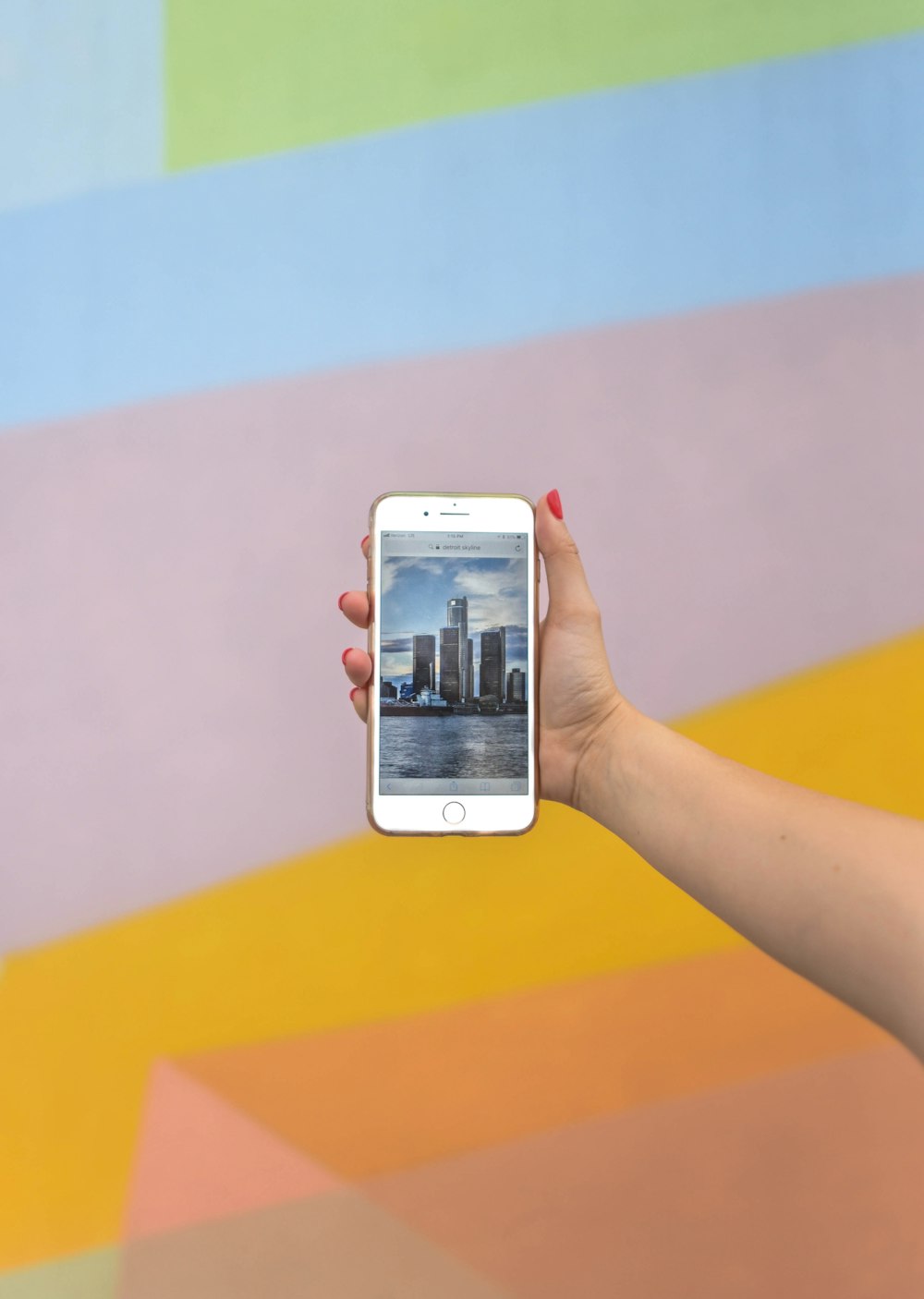 person showing high-rise buildings using iPhone