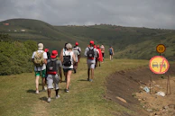 A group of walkers on a gently sloping path in Dolina Chochołowska, some using the hypershell for extra support.