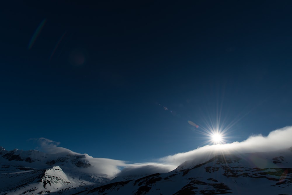 snow capped mountain under clear blue sky at daytime