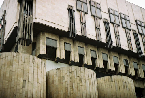 A modern brutalist office building exterior with strong geometric lines and concrete textures.