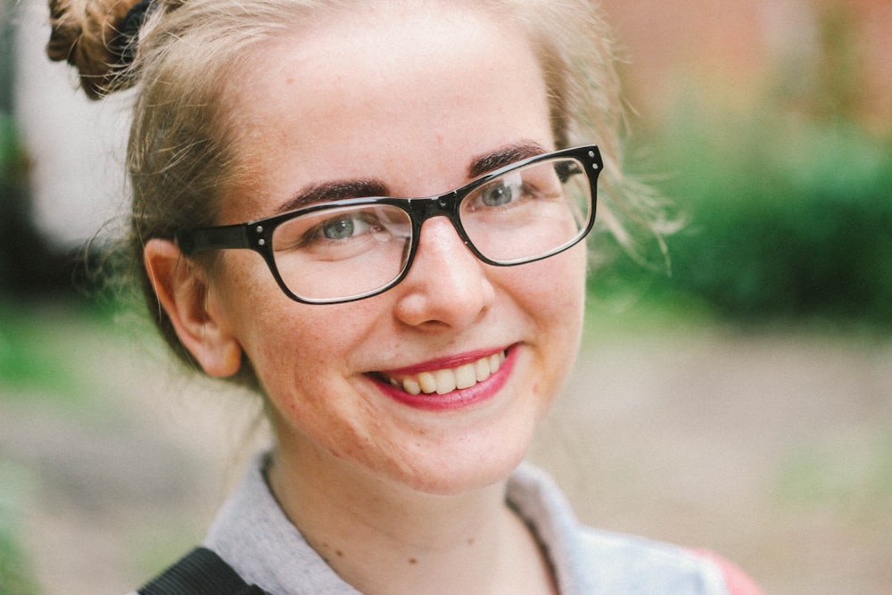 woman wearing eyeglasses while smiling