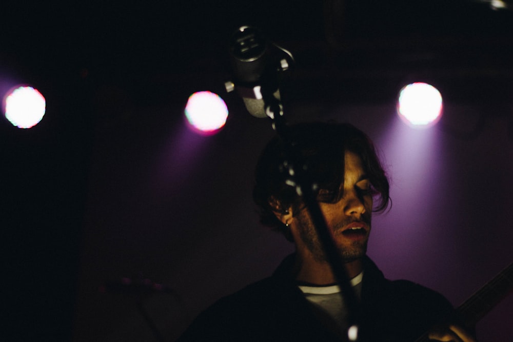 man standing in front of microphone