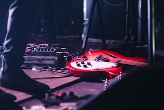 red electric guitar on flooring