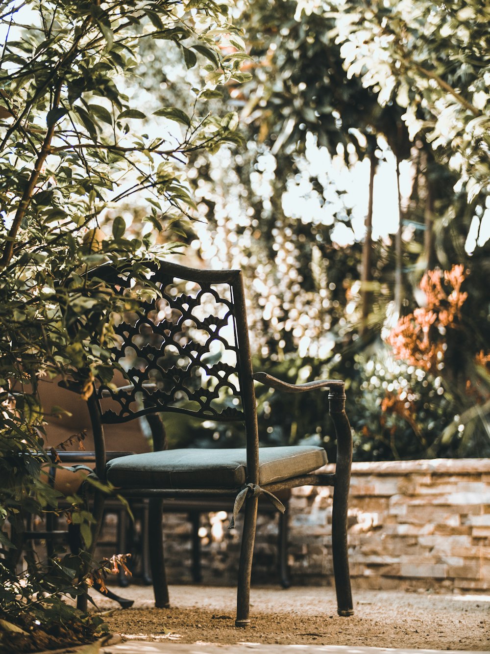 brown wooden armchair on gray sand