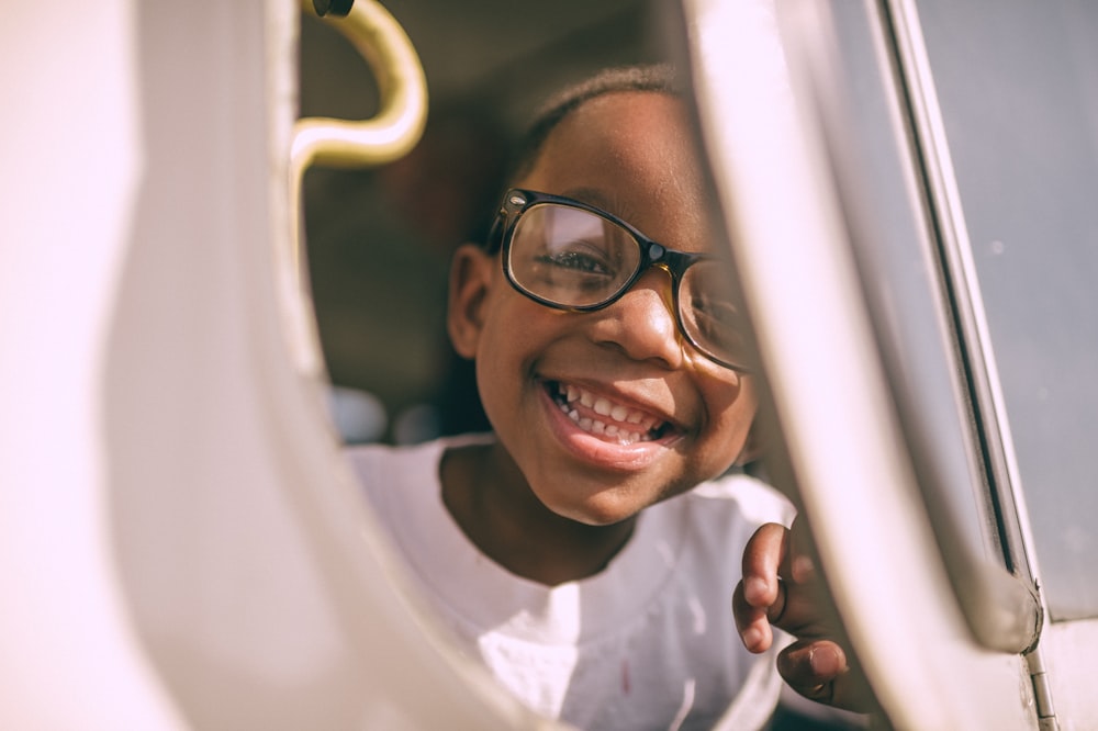 boy taking picture on window