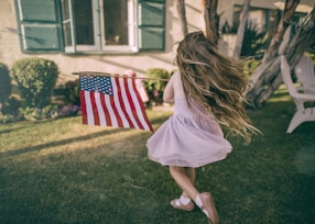 girl holding flag of USA