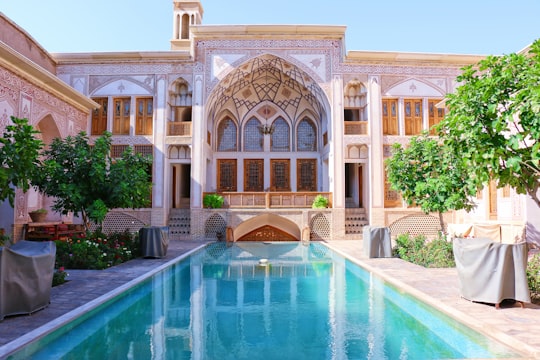 swimming pool near building and trees in Agha Bozorg Mosque Iran