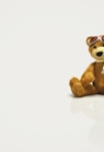 brown bear plush toy on white surface