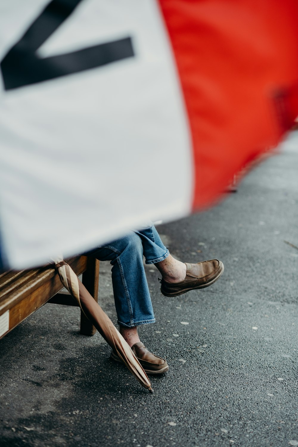 person sitting on bench wearing brown leather shoes