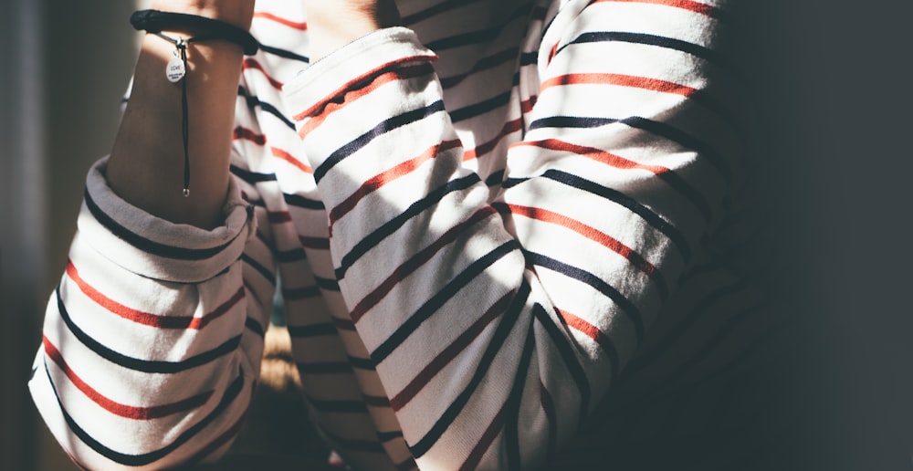 woman sitting wearing striped shirt