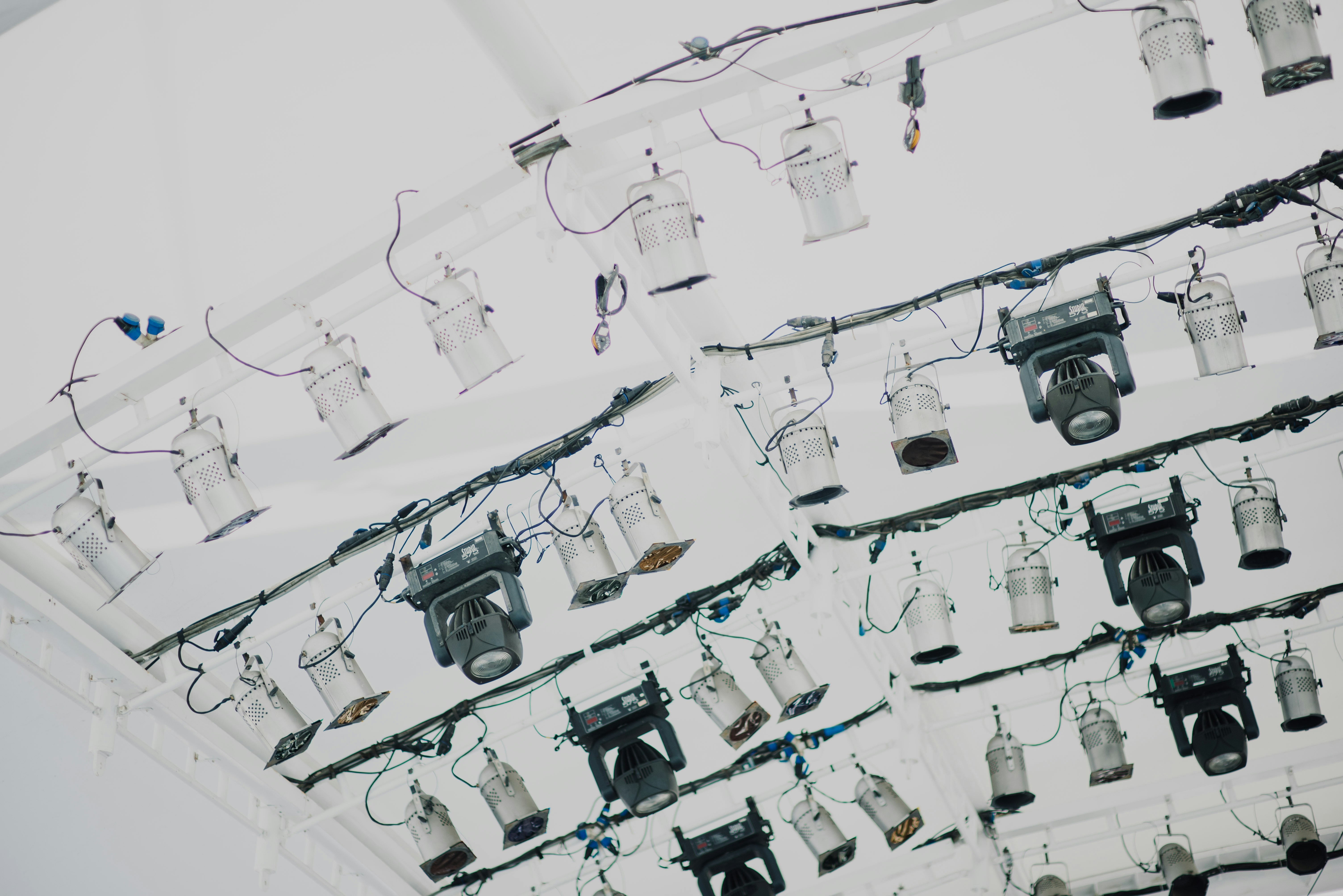 An aerial view of a team of investigators, some in white suits, examining small pieces of wreckage scattered on the ground. They are meticulously documenting the scene with cameras and measuring tools.