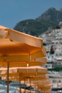aligned orange patio umbrellas near mountain