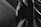 High-contrast image of a minimalist, draped fabric silhouette against a dark background.