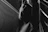 High-contrast image of a minimalist, draped fabric silhouette against a dark background.