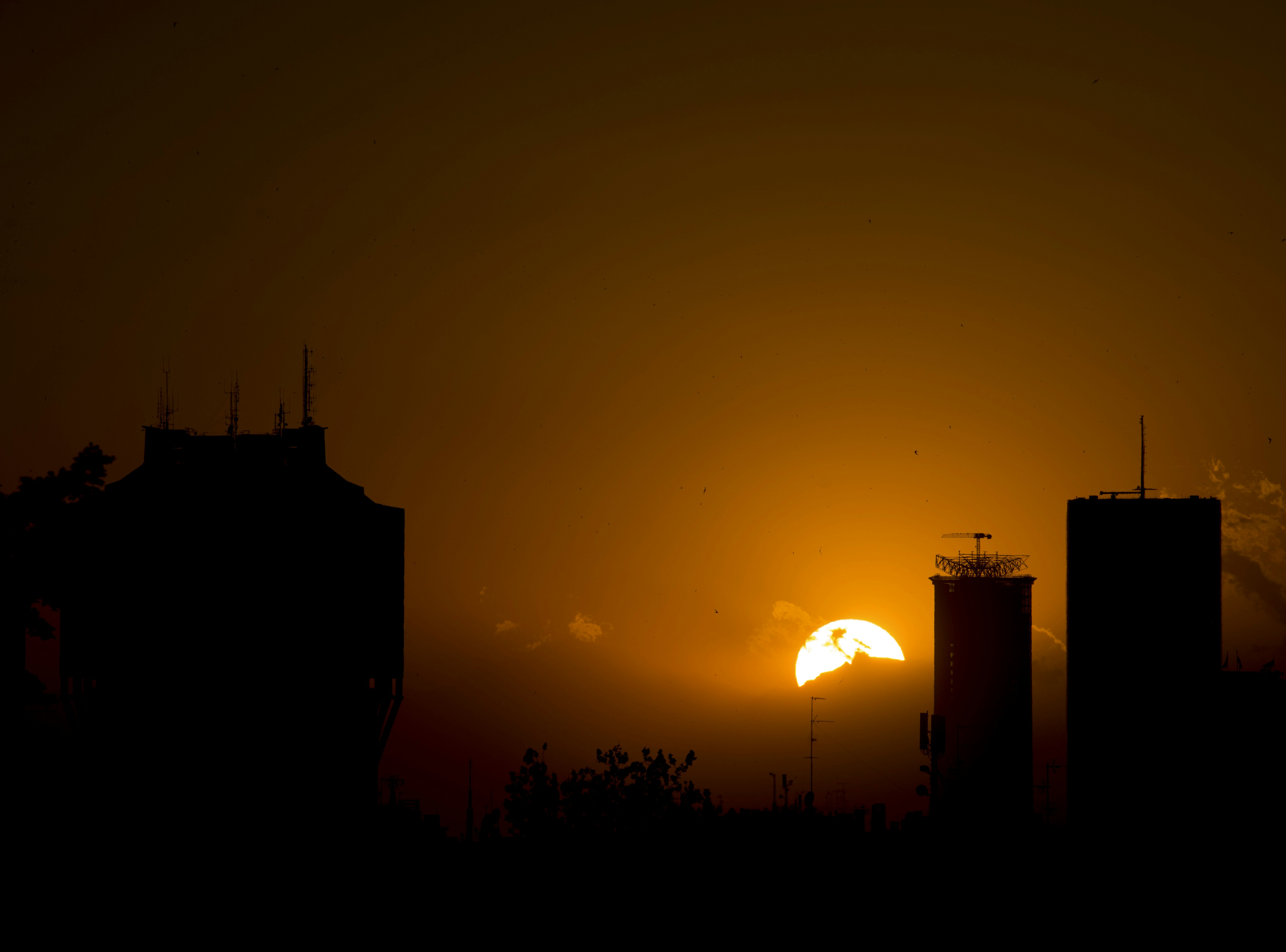 silhouette on high-rise buildings with full moon background