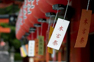Students sharing a joyful moment during a Japanese language workshop, surrounded by traditional decorations.