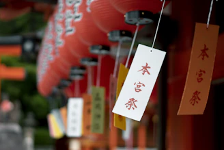 Students sharing a joyful moment during a Japanese language workshop, surrounded by traditional decorations.