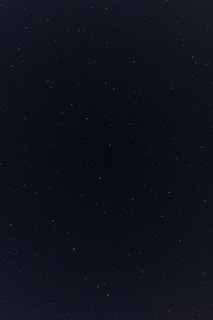 a night sky with a few stars in it