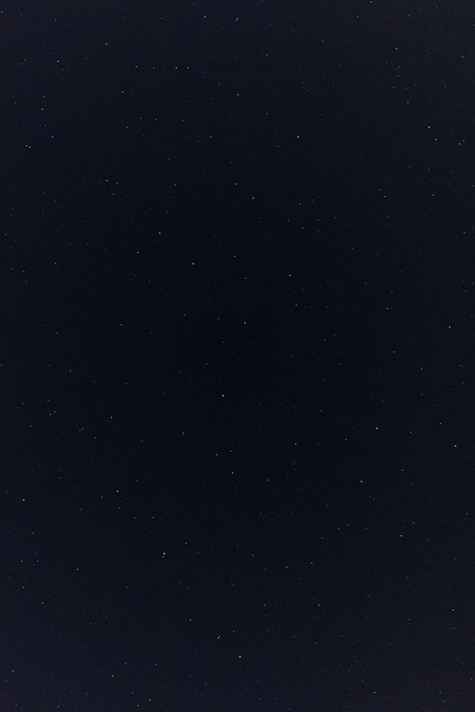 a night sky with a few stars in it