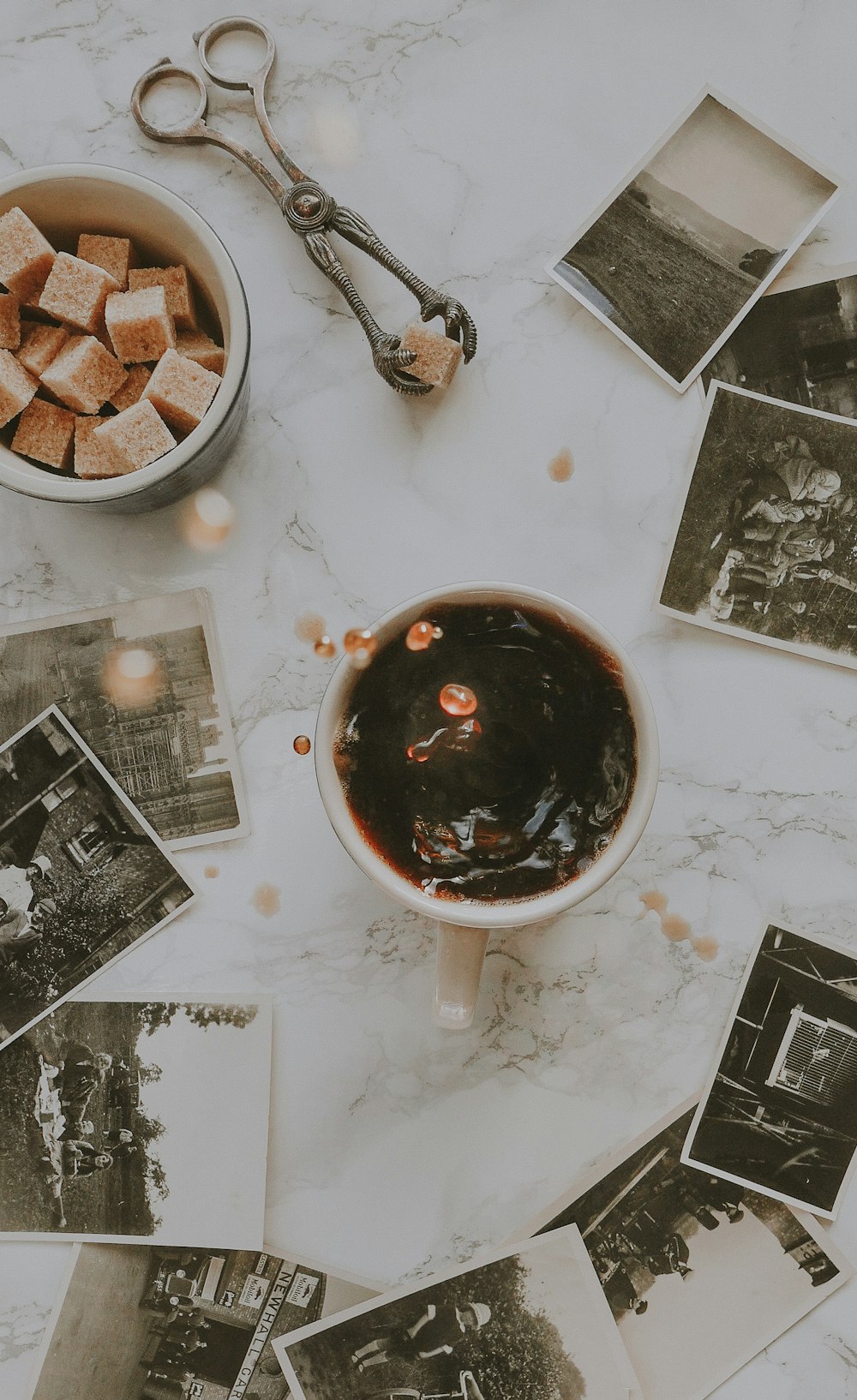 sugar cube dropped into cup of coffee creating spill